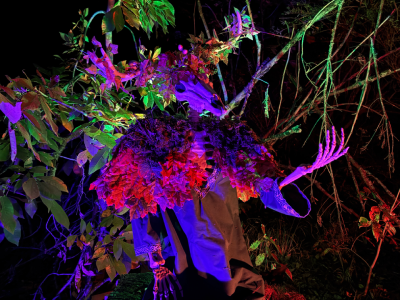 A deer headed forest god draped in moss and leaves. 