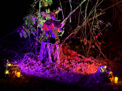 A deer headed forest god draped in moss and leaves. 