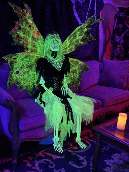 The Green Fairy sitting in our front room in purple and blacklight. 