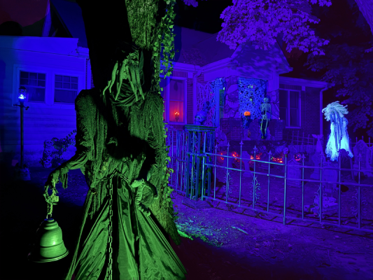 A Halloween scene centered on an Illithid with a graveyard in the background. 