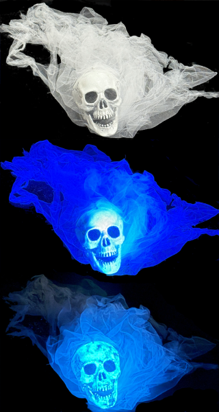 A graveyard spirit Halloween prop in regular, blacklight, and glowing in the dark.