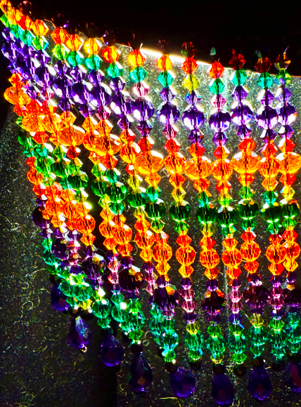 Beaded fringe in oranges, greens, and purples.