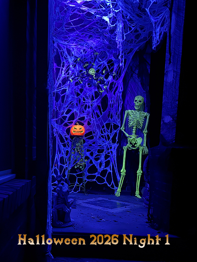A porch covered in spiderwebs, a glowing skeleton, a glowing jack o lanters, and a large spider adorn the webs.Text says Halloween 2026 Night 1